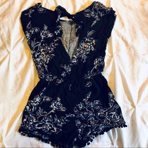 Black floral print romper w/ open back now detail